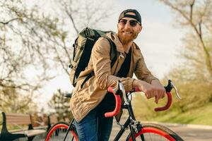 stilig skäggig man reser med cykel i morgon- foto