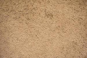 väderbitna naturlig brun lera jord hus vägg bakgrund foto