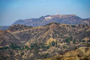 berömda hollywoodskylt på en kulle på avstånd foto