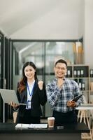 asiatisk företag kollega företag presenterar och förklarar och använder sig av bärbar dator och läsplatta. lagarbete, finansiell marknadsföring team, medan Sammanträde i modern kontor foto