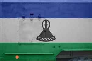 lesotho flagga avbildad på sida del av militär armerad lastbil närbild. armén krafter konceptuell bakgrund foto