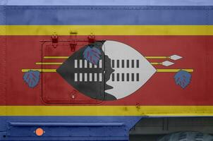 swaziland flagga avbildad på sida del av militär armerad lastbil närbild. armén krafter konceptuell bakgrund foto