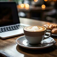 kaffe och laptop på skrivbordet foto