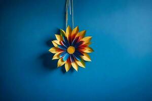 en färgrik papper blomma hängande på en blå vägg. ai-genererad foto