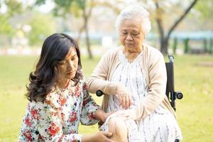 asiatisk senior kvinna patient på rullstol i park foto