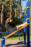 en Tonårs flicka håller på med abdominal crunches. foto