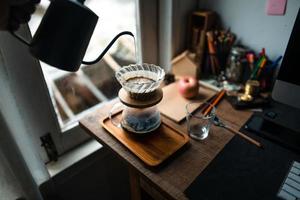 droppa kaffe i huset, häll varmt vatten över ett droppkaffe foto