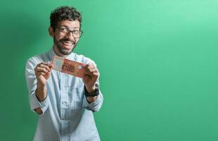 Lycklig person som visar du en enda räkningen. vänlig man med en leende som visar ett pengar räkningen isolerat, begrepp av person som visar en 500 nikaraguanska cordobas räkningen. foto