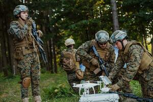 modern krigföring soldater trupp är använder sig av Drönare för scouting och övervakning under militär drift i de skog. foto