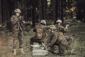 modern krigföring soldater trupp är använder sig av Drönare för scouting och övervakning under militär drift i de skog. foto