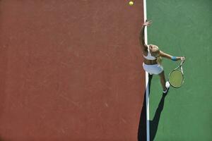 ung kvinna spela tennis utomhus foto