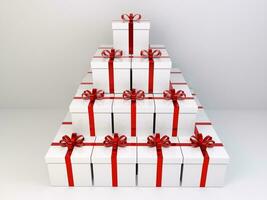 små torn av gåvor i vit lådor insvept med röd skinande band foto