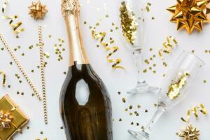 flaska av champagne med färgad glitter, konfetti och gåva låda Plats för text på color bakgrund, topp se. rolig, jul och födelsedag firande foto