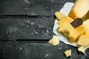 parmesan ost på papper med en kniv. foto