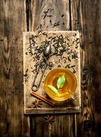 kopp av te med grön löv. foto