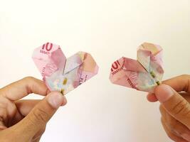 indonesiska rupiah pengar i hjärta formad. illustration för dela räkningen med partner foto