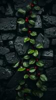 svart sten vägg med röd bär och grön löv generativ ai foto