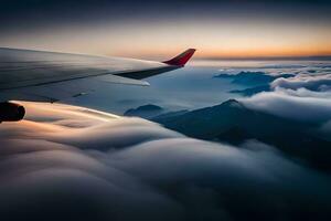 ett flygplan vinge är flygande över moln och berg. ai-genererad foto