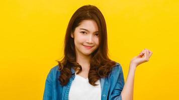 asiatisk kvinna med positivt uttryck över gul bakgrund. foto