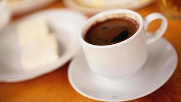 en kopp kaffe i en vit kopp på träbakgrund
