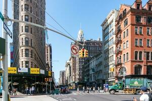 ny york stad, USA - augusti 9, 2019-människor promenader bland de känd skyskrapa kallad fatiron byggnad i manhattan under en solig dag foto