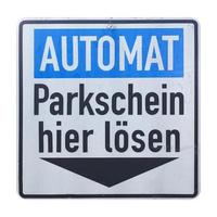 tyskt tecken isolerat över vitt. betala parkeringsbiljett här foto