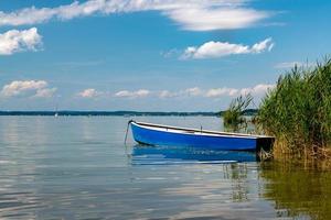 roddbåt ligger på stranden av Chiemsee i Bayern med vass foto