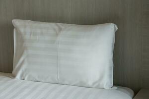 vit kuddar på en säng bekväm mjuk kuddar på de säng. foto