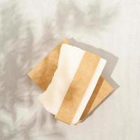 ovanifrån av handgjord tvål med hantverkstomt band på vitt texturerat foto