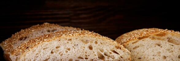 ciabatta bröd. skivad bitar av bröd på en trä- bakgrund. foto