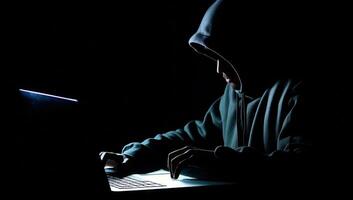 huvor hacker använder sig av en bärbar dator på en mörk bakgrund. Cyber brott begrepp. ai genererad. foto