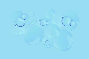 droppar av transparent gel med luft bubblor på en blå bakgrund foto