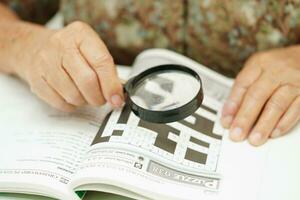 Bangkok, thailand - Maj 15, 2022 äldre kvinna spelar sudoku pussel spel för behandling demens förebyggande och alzheimers sjukdom. foto