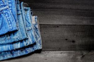blå jean och jean saknar konsistens på bordet, jeans överlappar varandra. foto