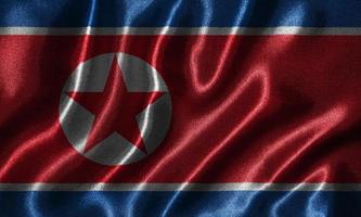 tapeter av Nordkoreas flagga och viftande flagga av tyg.