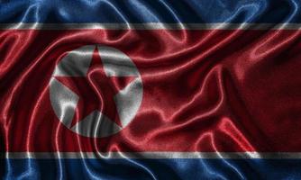 tapeter av Nordkoreas flagga och viftande flagga av tyg.