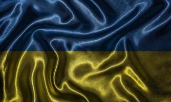 tapeter av ukrainska flaggan och viftande flagga av tyg. foto