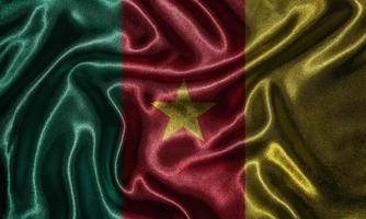 tapeter av Kamerun flagga och viftande flagga av tyg. foto