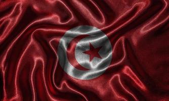 tapeter av tunisiens flagga och viftande flagga av tyg. foto