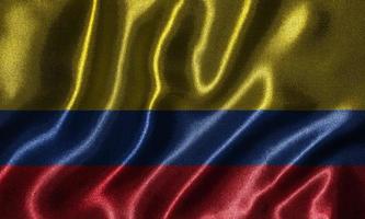 tapet av colombia flagga och viftande flagga av tyg. foto