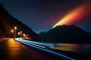 en regnbåge ljus lyser över en väg och berg. ai-genererad foto