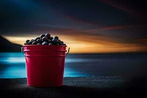 en röd hink fylld med svart oliver på de strand. ai-genererad foto