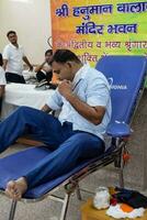delhi, Indien, juli 19 2023 - blod givare på blod donation läger hölls på balaji tempel, vivek vihar, delhi, Indien, bild för värld blod givare dag på juni 14 varje år, blod donation läger på tempel foto