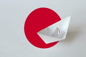 japan flagga avbildad på papper origami fartyg närbild. handgjort konst begrepp foto