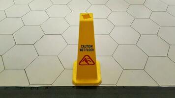 gul varning hal våt golv tecken. hal tecken på våt golv i en byggnad. foto