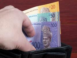 malaysiska pengar i de svart plånbok foto