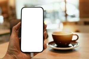 cell telefon tom vit skärm mockup.woman hand innehav smart mobil telefon, använder social media med suddigt kaffe affär bakgrund, tom Plats för annonsera text, affärer, kommunikation, teknik foto