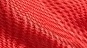 röd fotboll tyg textur med luft maska. sportkläder bakgrund foto