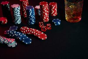 poker pommes frites och vin glas av cognac på mörk tabell. hasardspel foto
