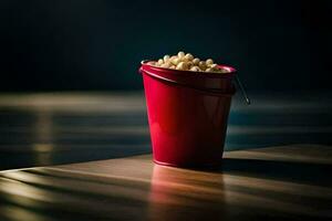 en röd hink fylld med popcorn på en trä- tabell. ai-genererad foto